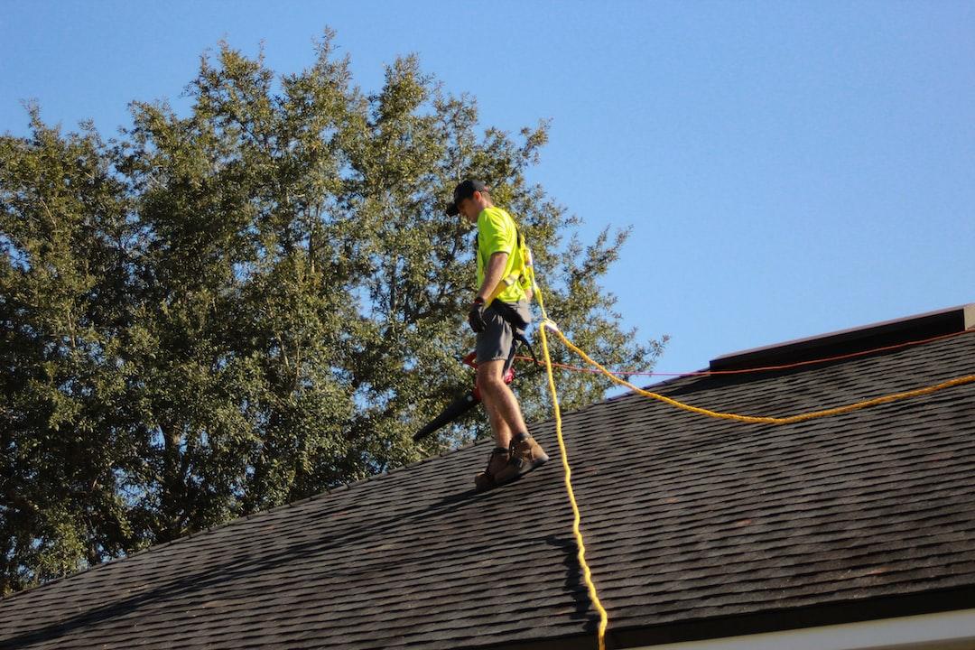 A contractor walks on top of a roof.