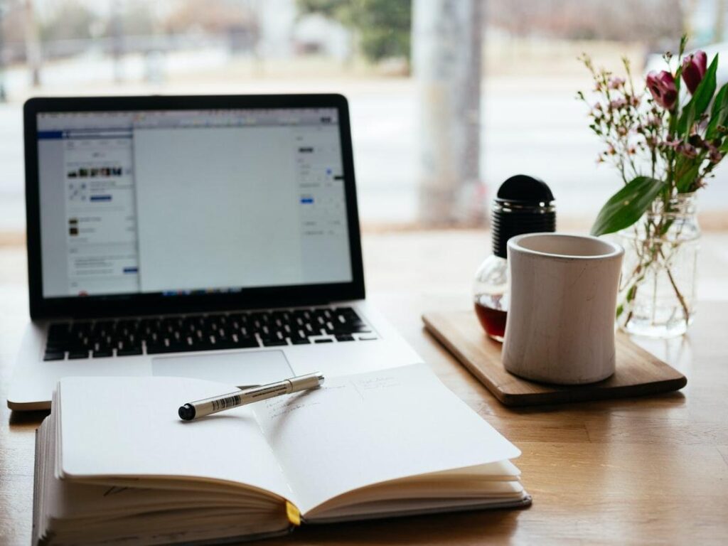 Notebook and laptop ready to evaluate employee training tracking software